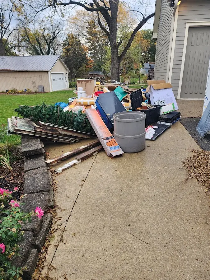 Dumpster being loaded with debris for Roofing Dumpster Rental in Rockcreek